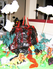 Let your imagination run wild! Locate palm trees, edible rocks, and dinosaurs at cake supply and party stores. The virgin sacrifice and villagers above were hand-crafted from marzipan. 