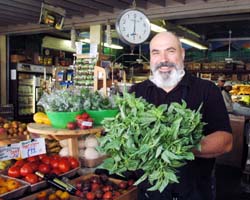 Dan Avakian shows off a bundle of basil--perfect for making and freezing pesto. Beyond Wonderful Produce Expert.