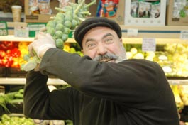 Dan Avakian with a very large stick of Brussels Sprouts.